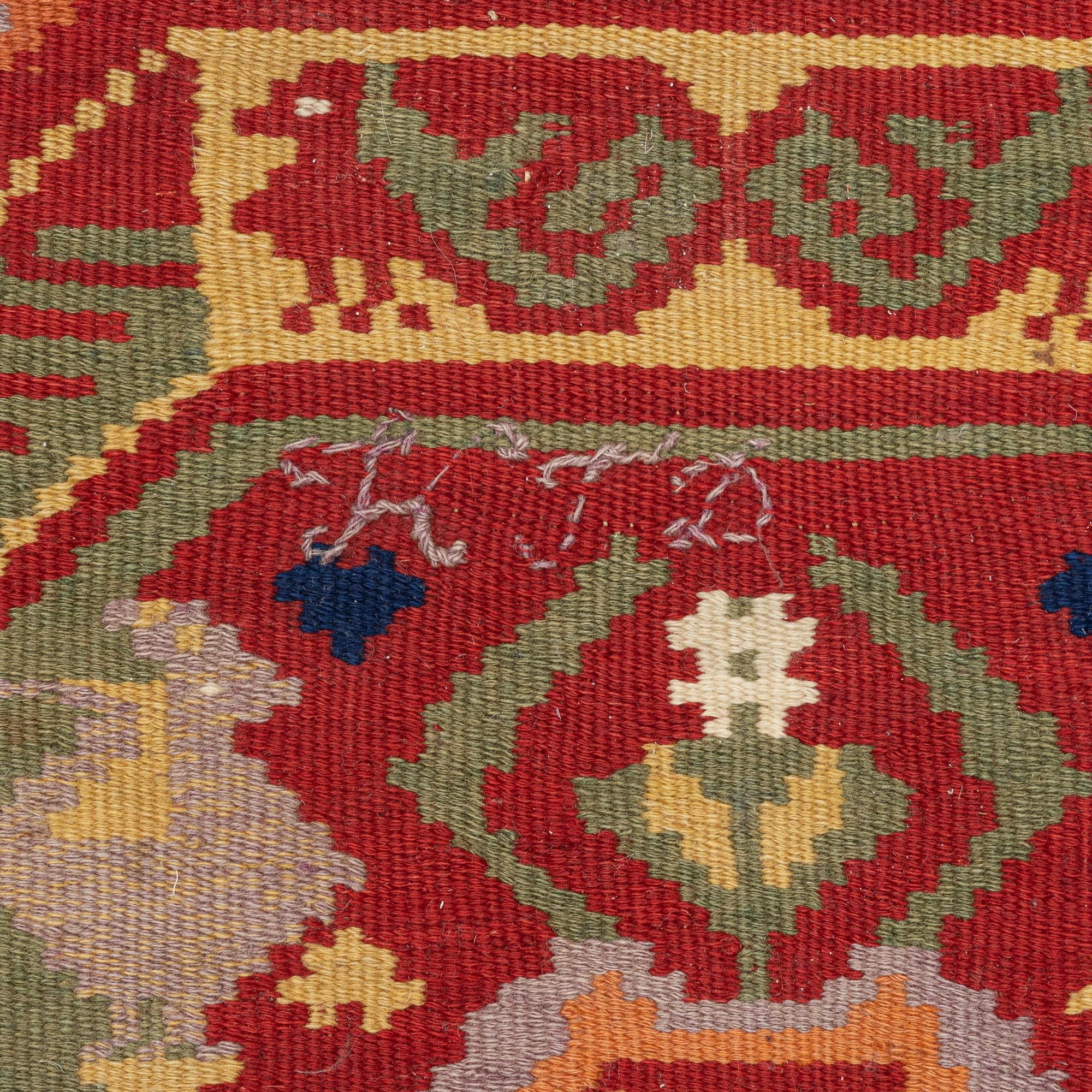 A double-interlocked tapestry carrige cushion, c 100 x 50 cm, Scania, mid 19th century.