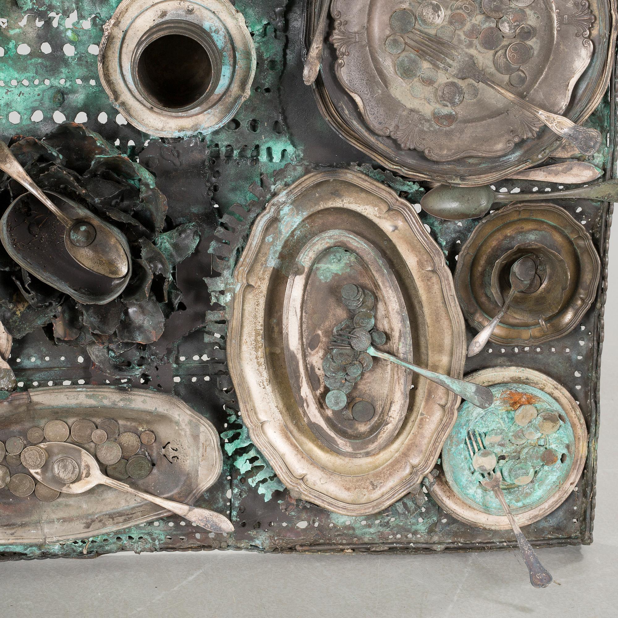 a metal sculpture, signed.