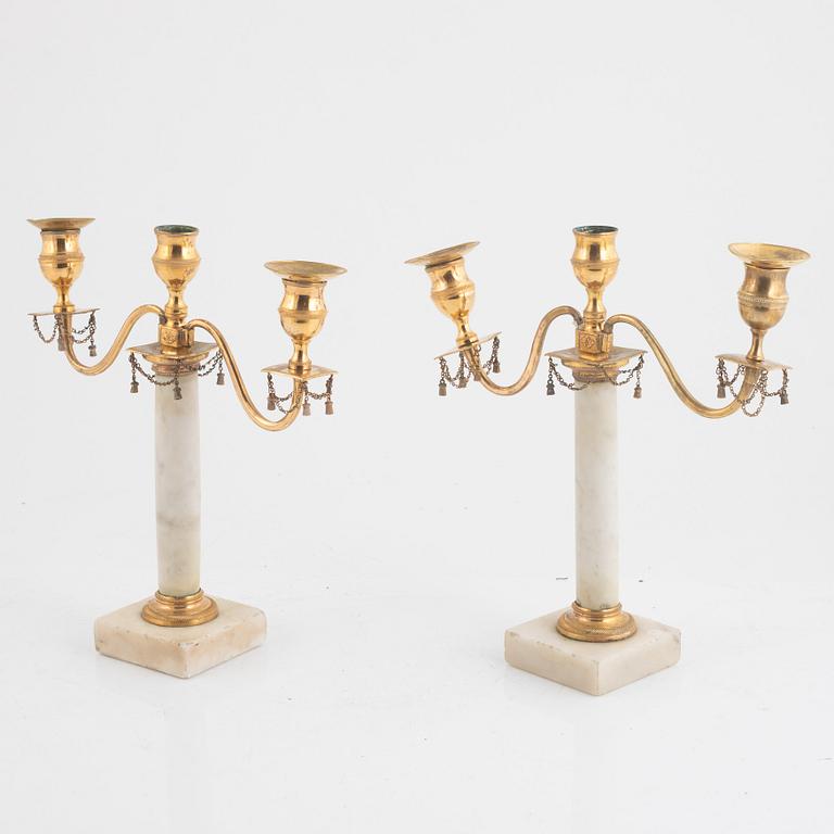 A pair of late Gustavian three-light white marble and gilt brass candelabra, late 18th century.