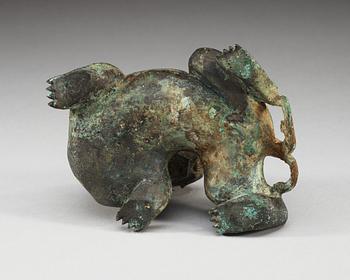 An archaistic bronze figure of a mythological beast.