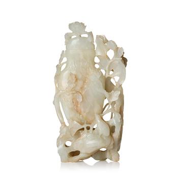 1033. A well sculptured pale green and russet coloured nephrite vase with cover, 20th century.