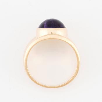 Georg Jensen, an 18K gold ring set with a cabochon-cut amethyst, Copenhagen post 1945, design nr 1124.