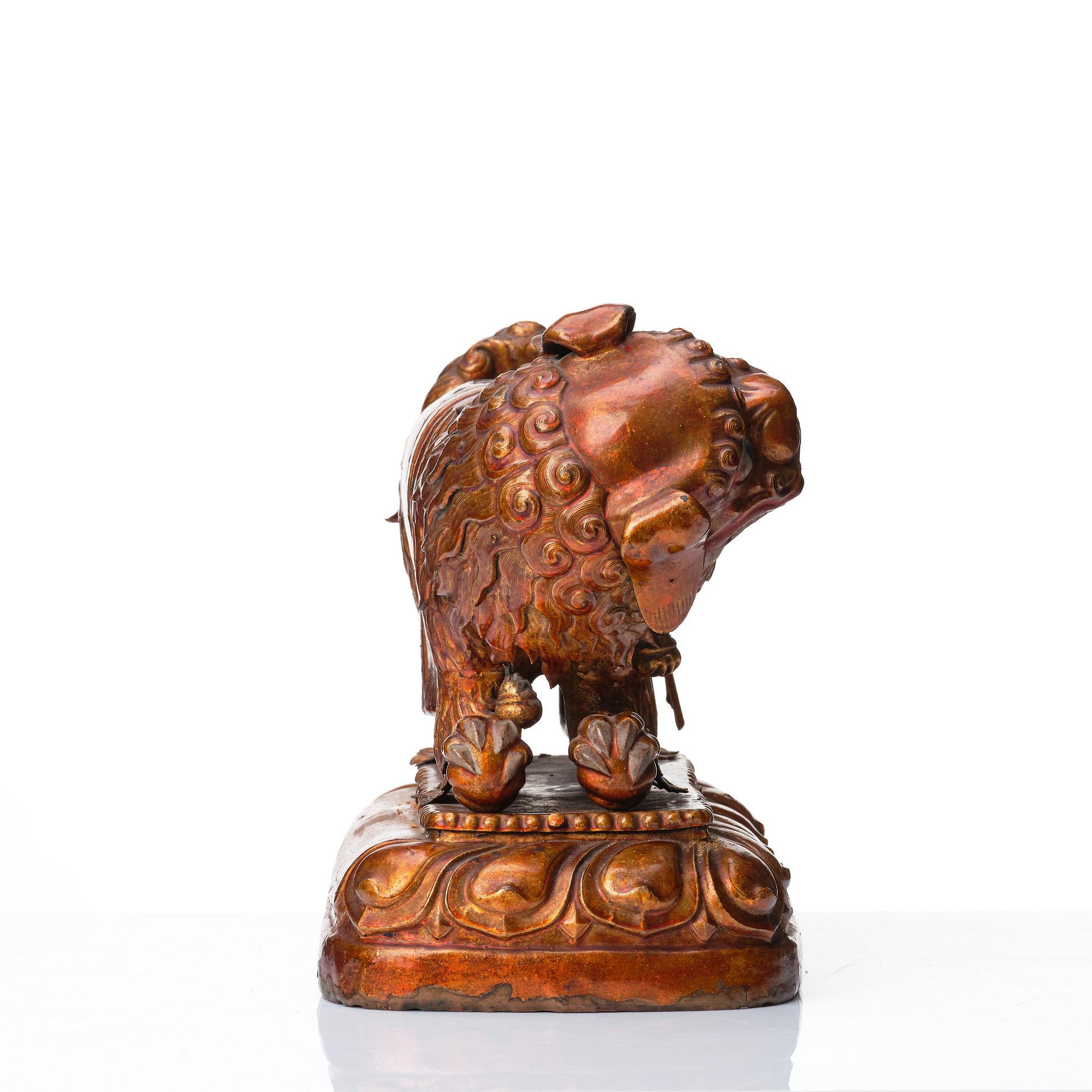 A cold gilt and lacquered copper alloy sculpture of a buddhist lion, Tibeto-Chinese/Mongolian, 18th Century.