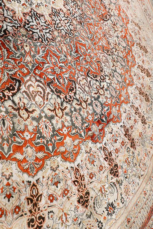 An Oriental silk rug, diameter 256 cm.