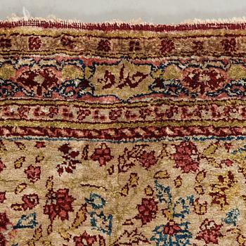 A CARPET, a semi-antique silk Tabriz figural, signed Haddad, 180,5 x 123,5 cm.