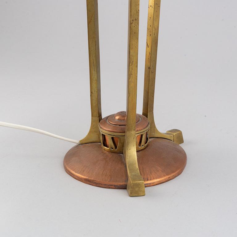 An early 20th century, brass and copper table lamp.