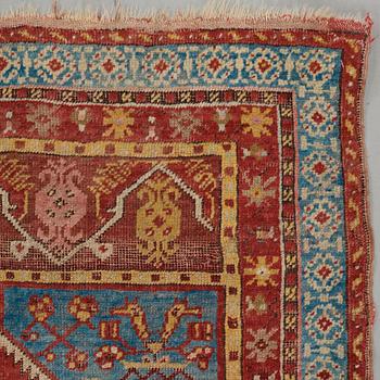 A RUG, an antique Anatolian, the Ottoman Empire, ca 154,5-158 x 99,5-102,5 cm (as well as 1 cm flat weave at one end).