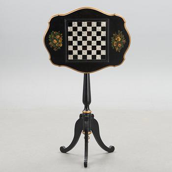 A Chinese tilt top chess table from the first half of the 20th century.