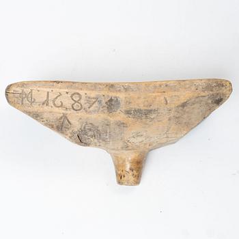 A Swedish carved wood milk funnel, dated 1687.