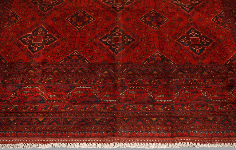An Afghan carpet, 343 x 243 cm.