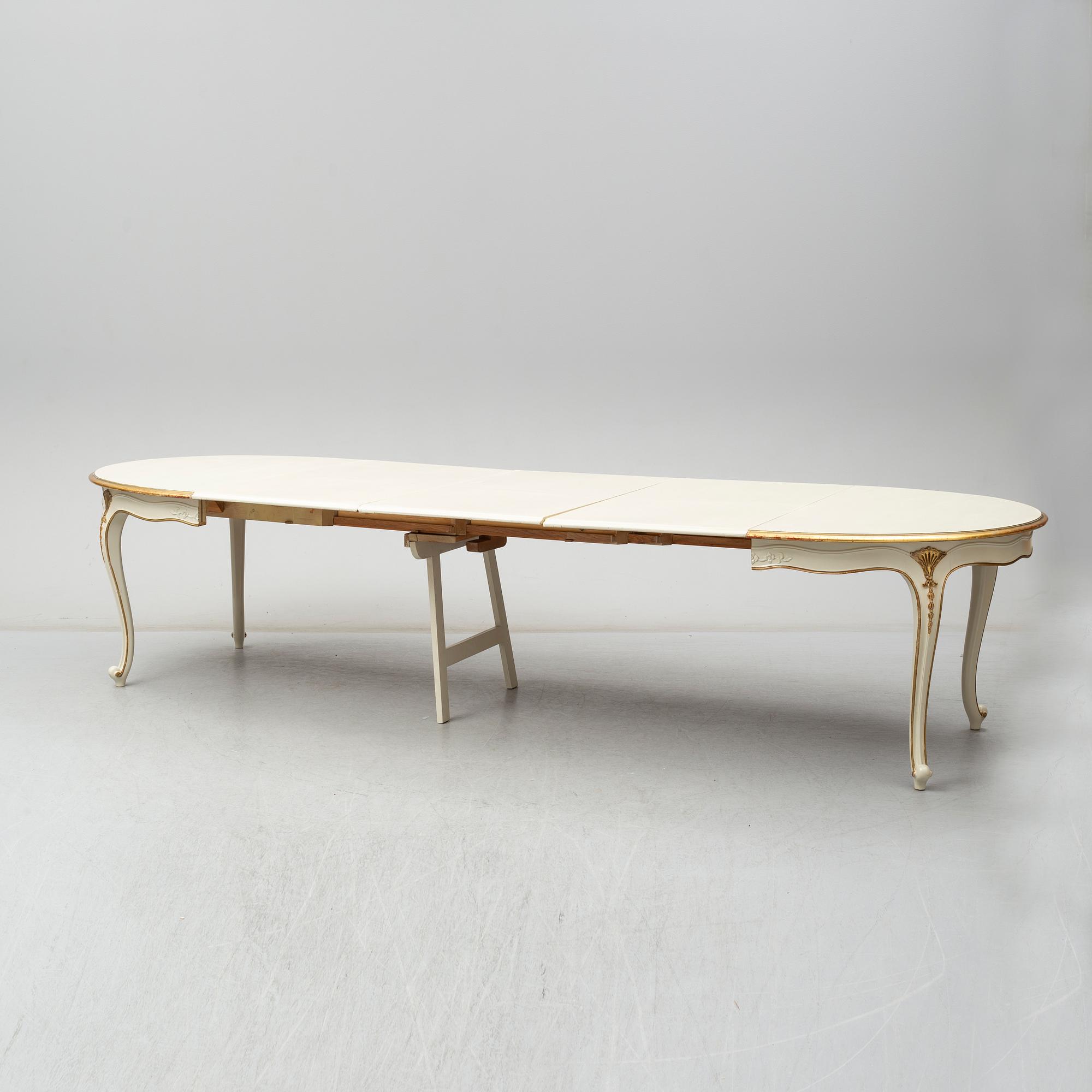 A dining table width twelve chairs, first half of the 20th century.