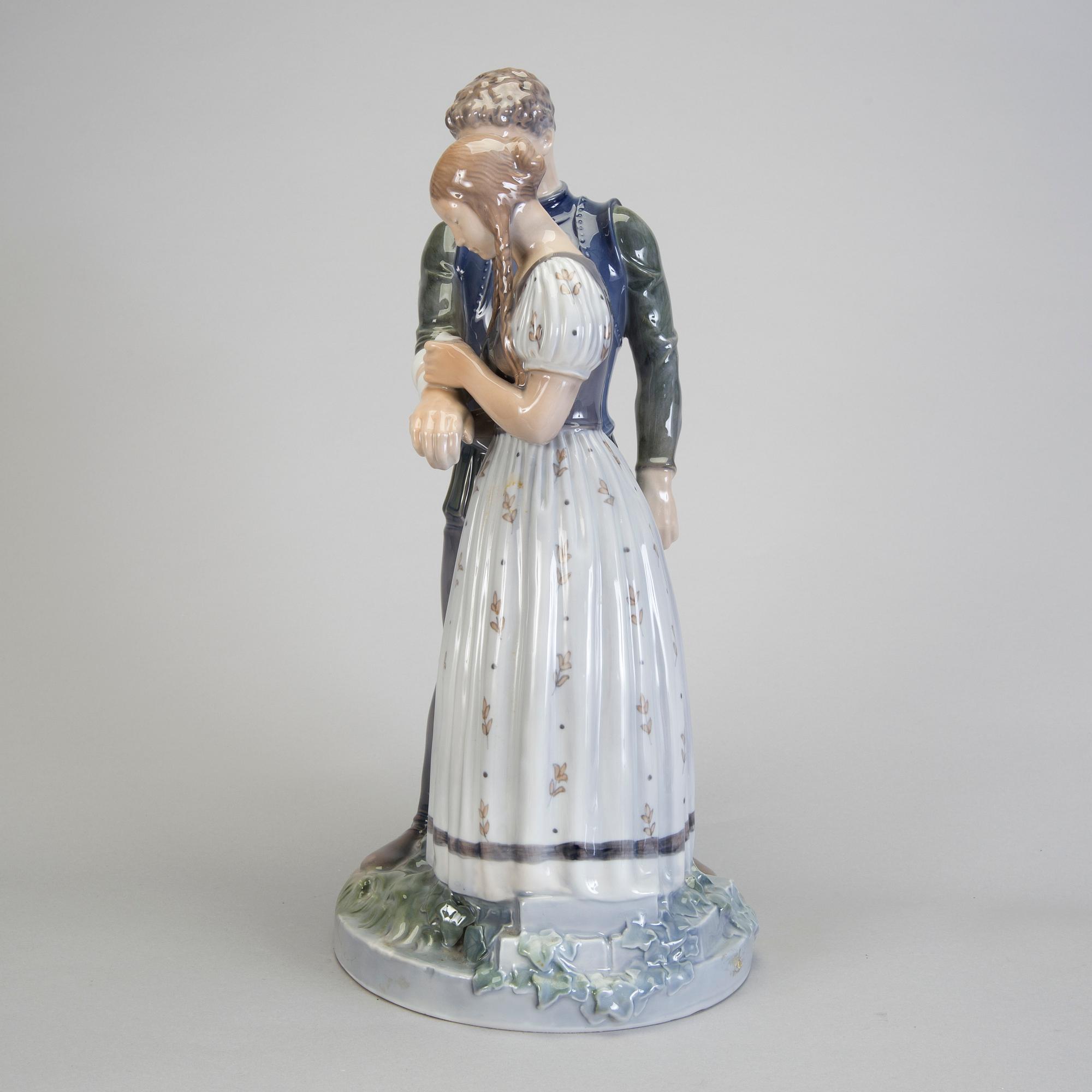 A porcelain figurine of a boy and girl model 3171 Royal Copenhagen.