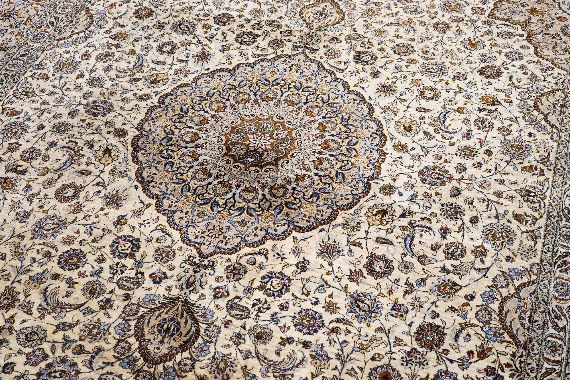 A semi-antique silk Keshan carpet, c. 350 x 248 cm.