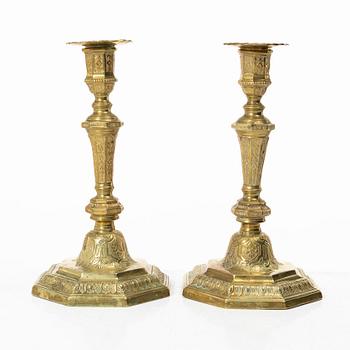 A pair of Louis XVI-style brass candle sticks, first half of the 20th century.