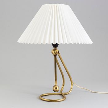 A Le Klint brass table or wall lamp.