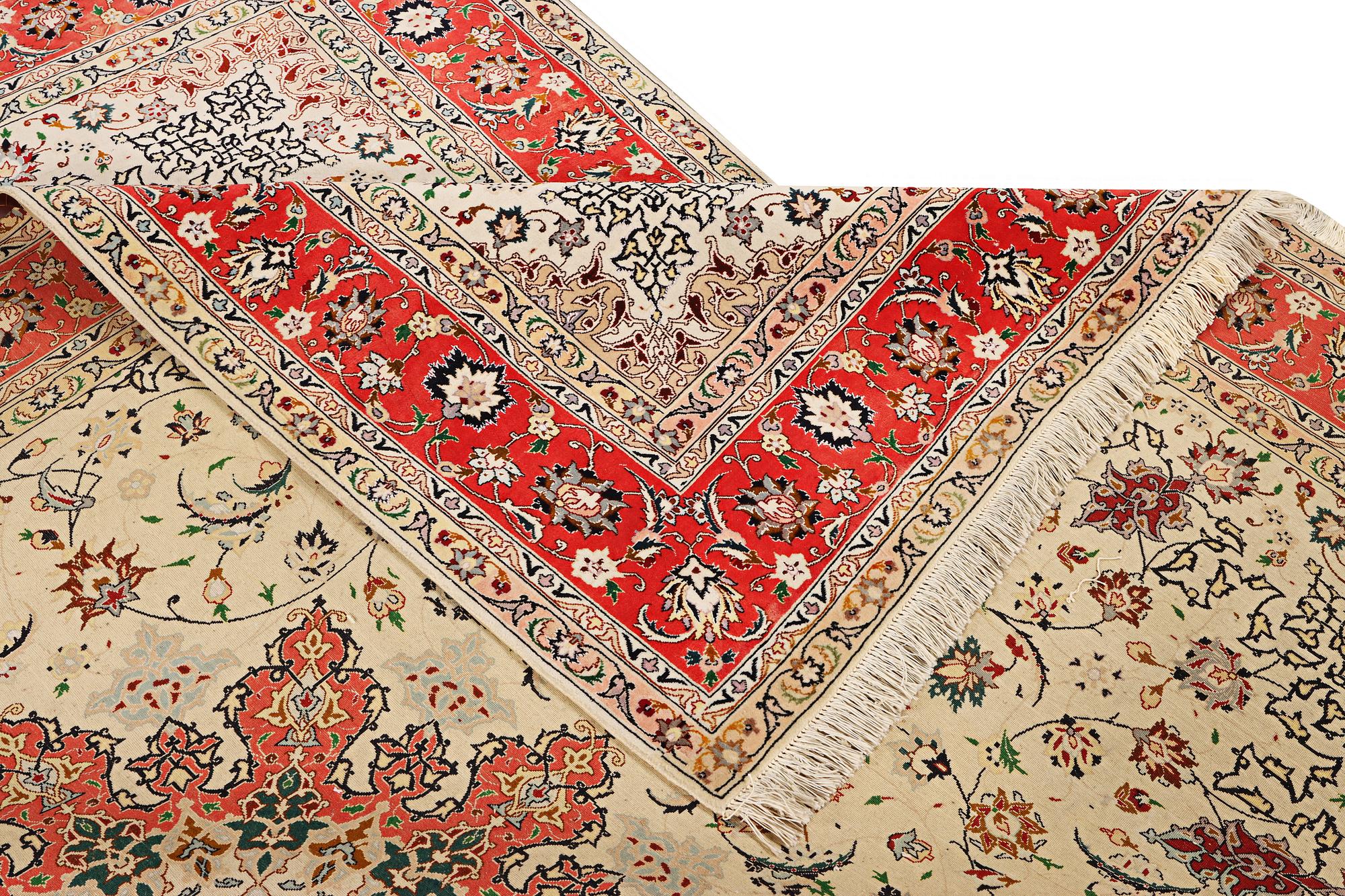A Tabriz, part silk carpet, c. 300 x 199 cm.