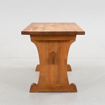A solid pine table attributed to Axel Einar Hjort.
