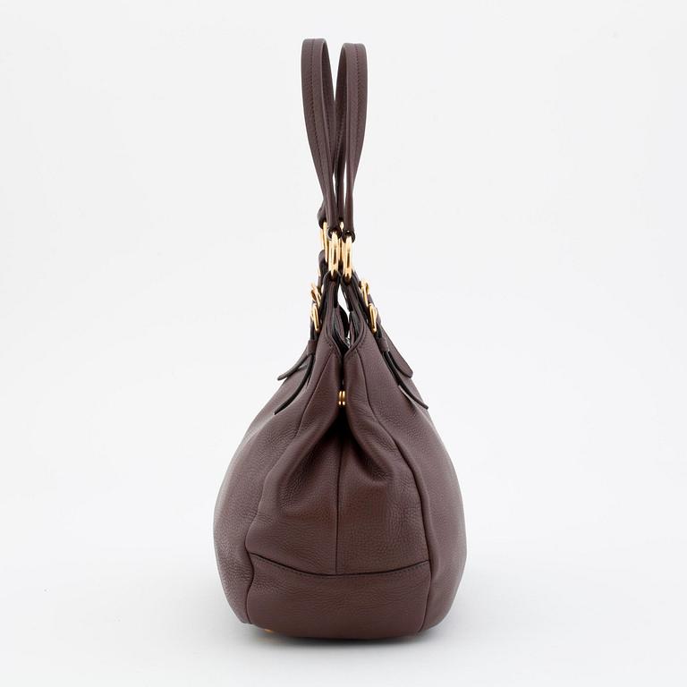 PRADA, a brown leather shoulder bag.