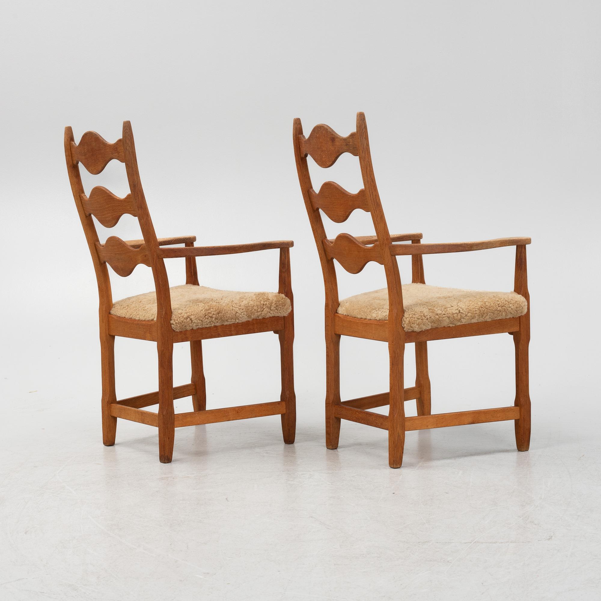 Henning Kjærnulf, a pair of oak 'Razorblade' armchairs with new sheepskin upholstery, from EGK, Demark, 1960s.