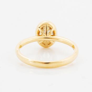 Oval light yellow diamond and brilliant-cut diamond ring.