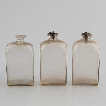 A wooden box with three glass flaska, first half of the 19th century.