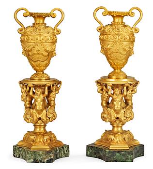 674. A pair of Italian 19th century gilt bronze and marble urns.