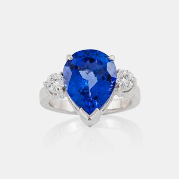 A pear-shaped tanzanite and brilliant-cut diamond ring. Total carat weight of diamonds 0.40 ct.