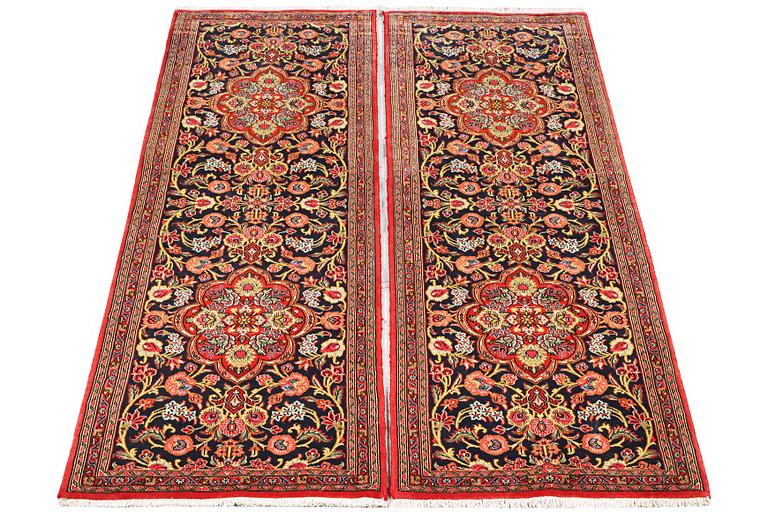 A pair of Quum rugs, c. 176 x 60 cm & c. 178 x 58 cm.