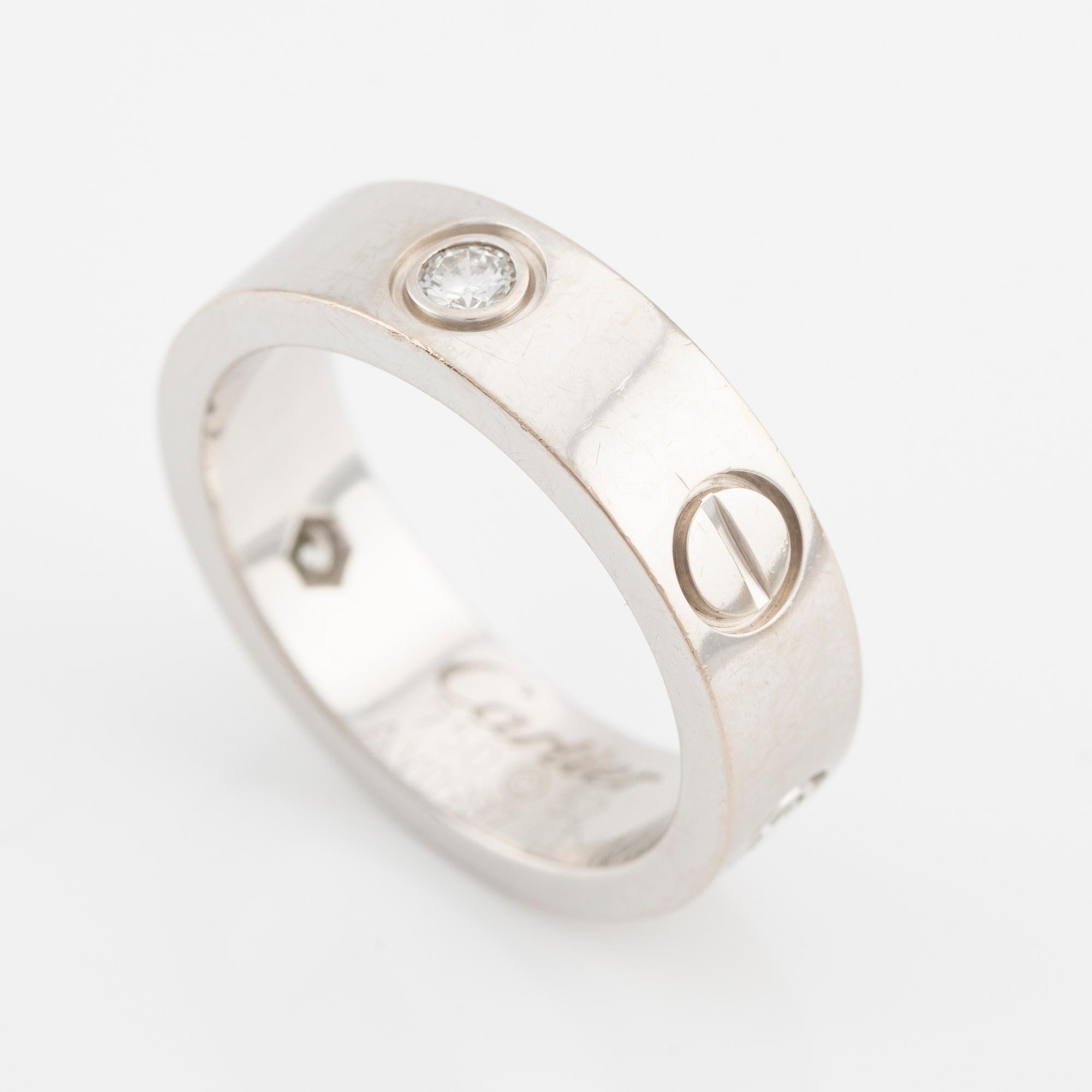 Cartier "Love" ring in 18K white gold with three round brilliant-cut diamonds.