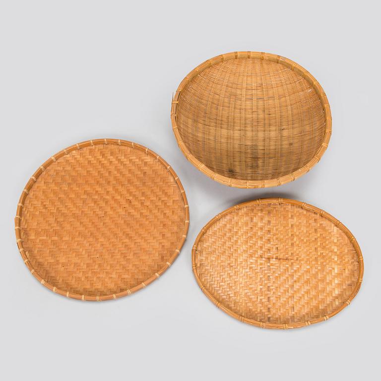 A mid-20th century rattan basket and two rattan trays. Retailer Artek Finland.
