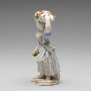 A Meissen figure of a girl with flowers, 1890's.
