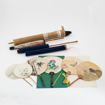 A set of six fans and two umbrellas and a wig/pony tail. Japan, early 20th Century.