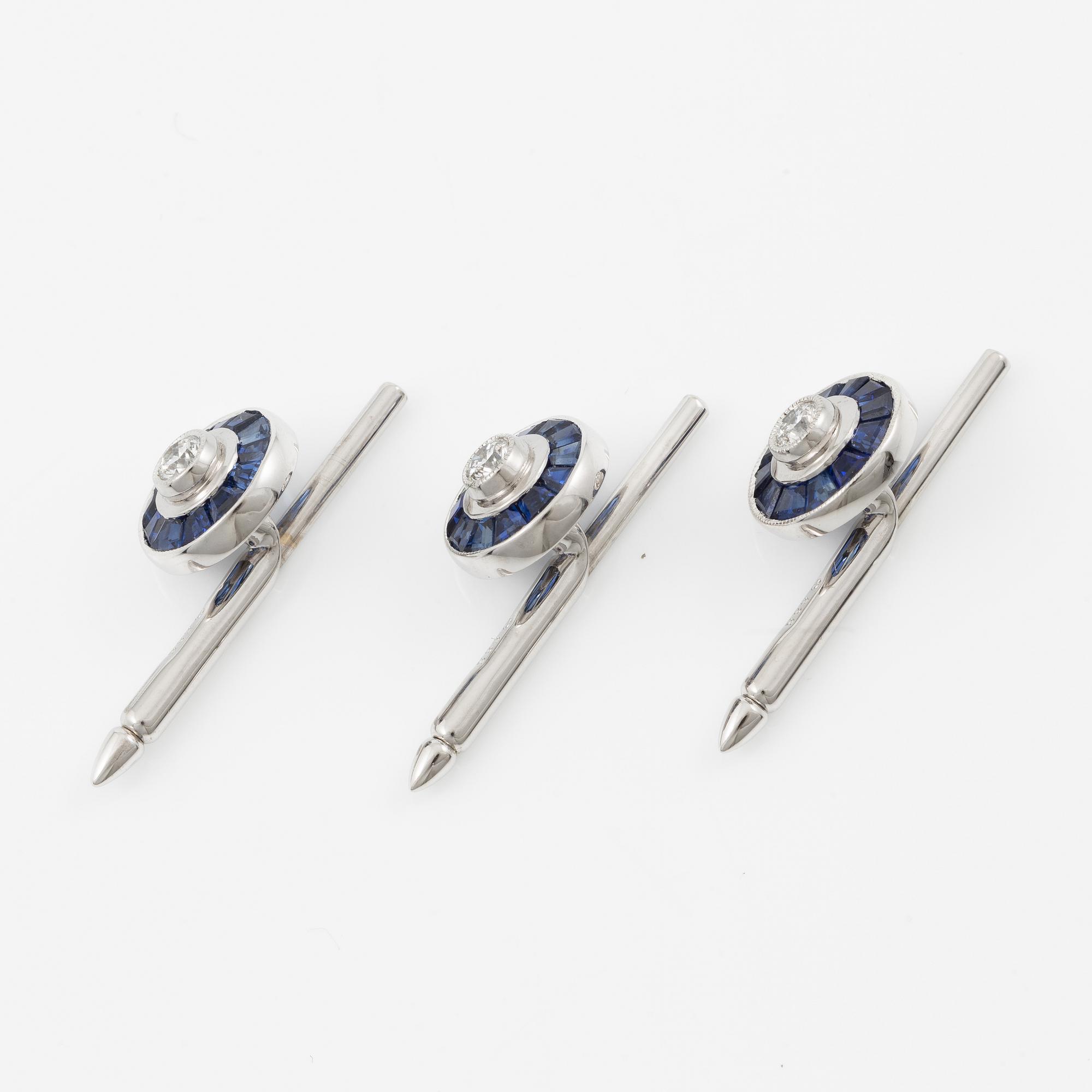 Three shirt buttons in 18K and 14K white gold set with faceted sapphires and round brilliant-cut diamonds.