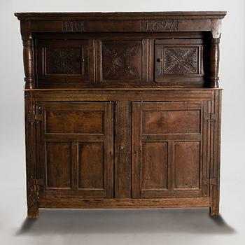 A QUEEN ANNE COURT CUPBOARD, oak, England dated 1697.