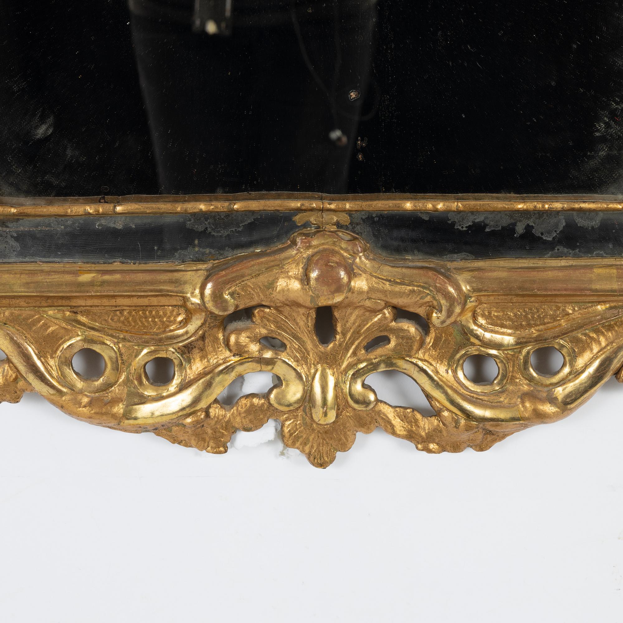 A Swedish giltwood rococo mirror, Stockholm, ltaer part 18th century.