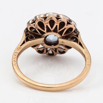 A 13-14K gold ring with a synthetic spinelle and rose-cut dimaonds.