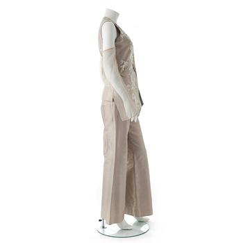 GIANFRANCO FERRÉ, a beige three-piece ensemble consisting of vest , trousers and skirt.