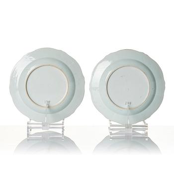 A pair of Chinese famille rose porcelain 'double peacock' plates, Qing dynasty, Qianlong (1736-95).