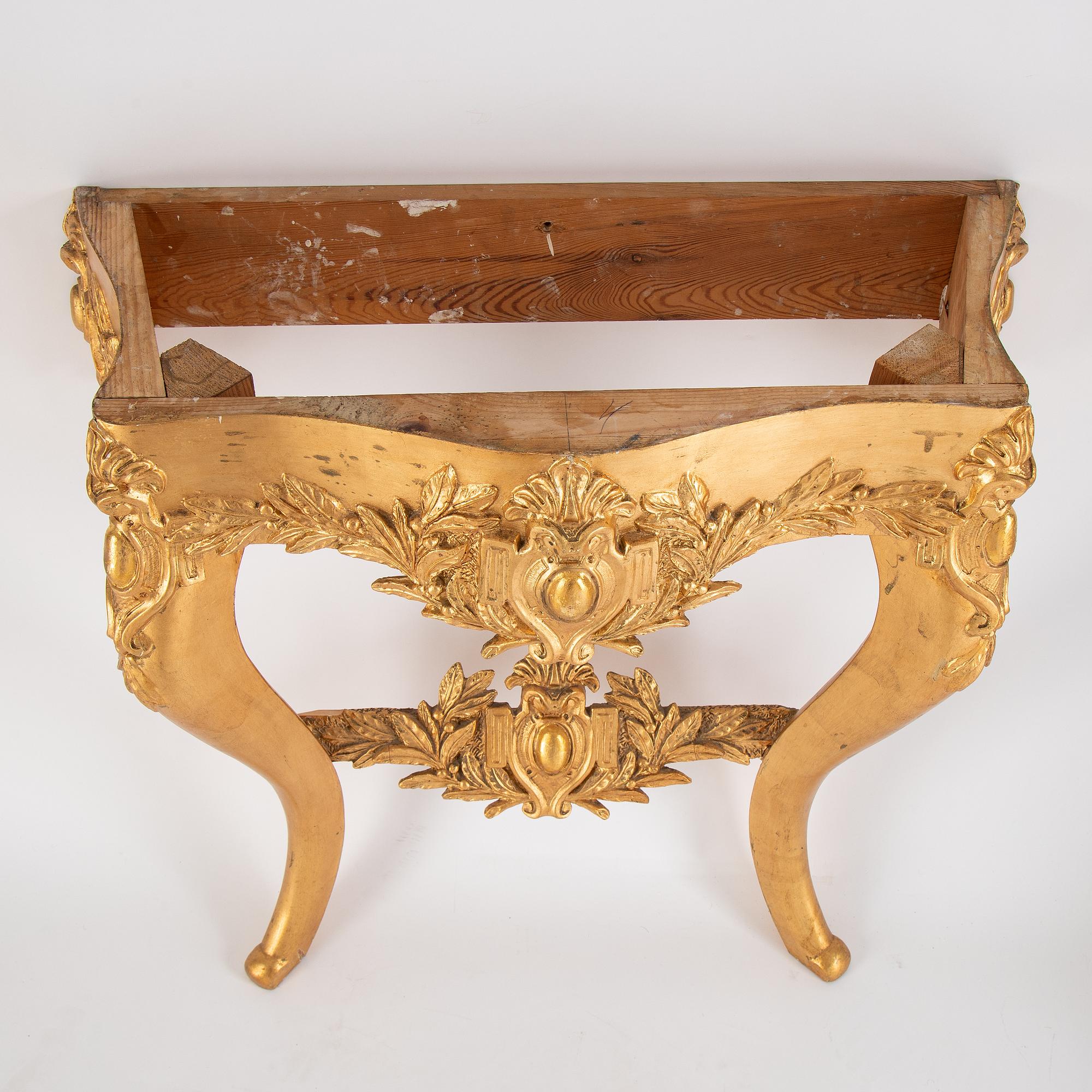 A mirror and console table from around the year 1900.