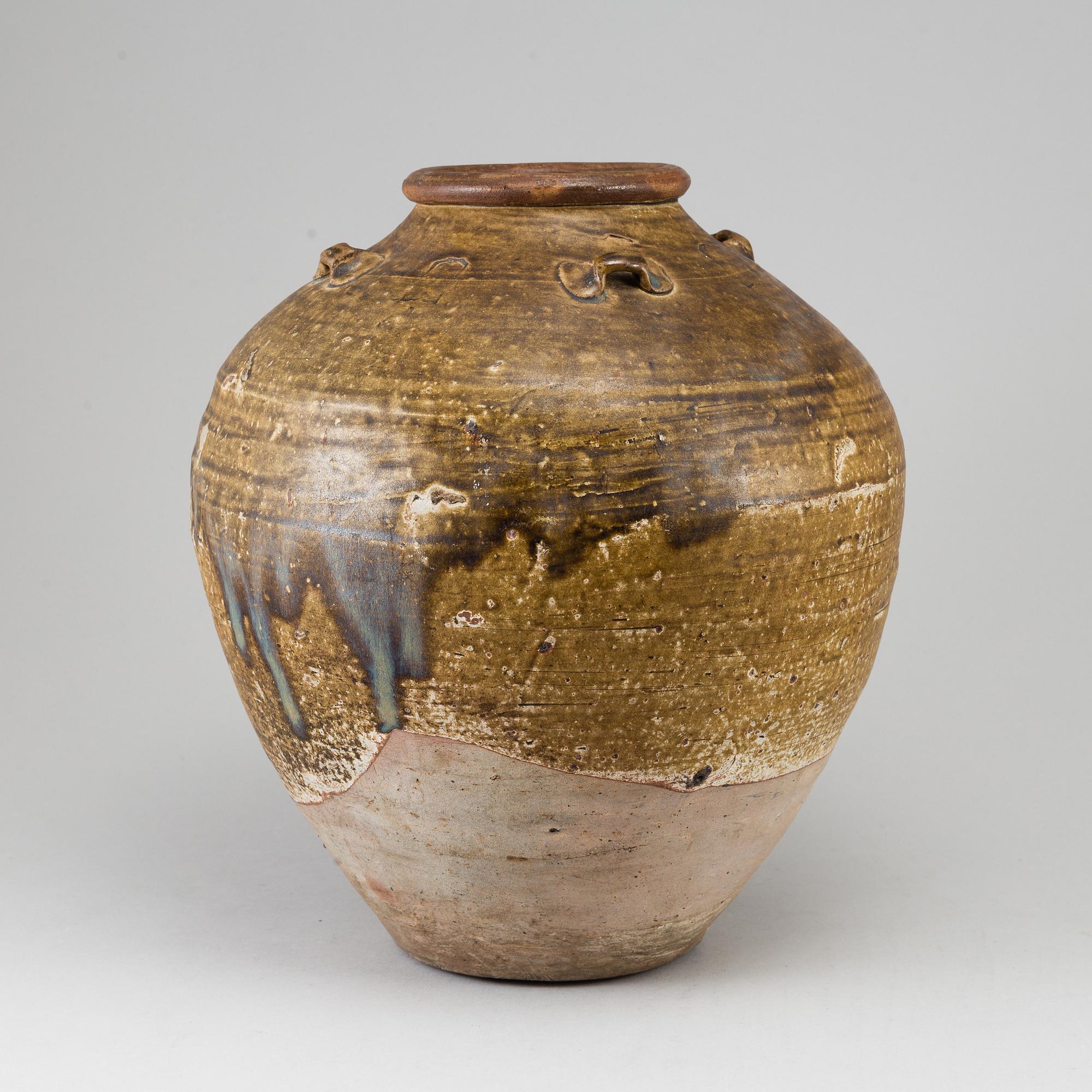 A olive green glazed jar, South East Asia, 18th Century or older.