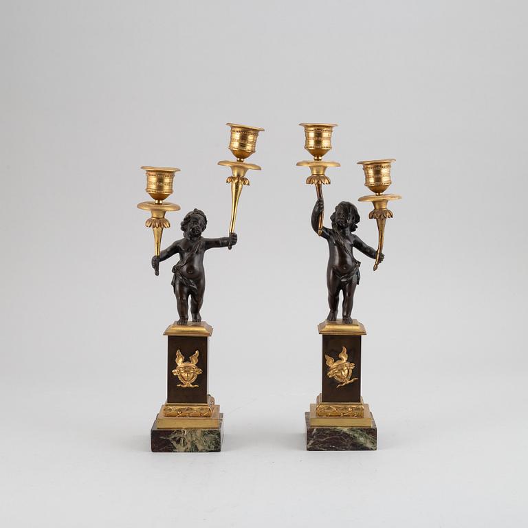 A pair of bronze empire style candleabra, 20th century.