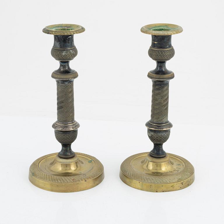 A pair of bronze Empire style candlesticks, 20th Century with older parts.
