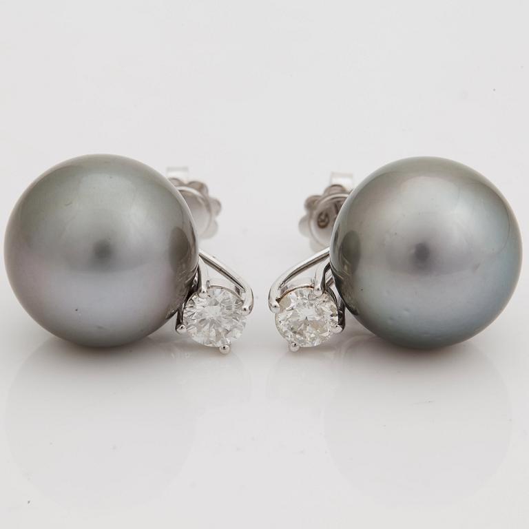 A pair of cultured Tahiti pearl and brilliant cut diamond earrings.