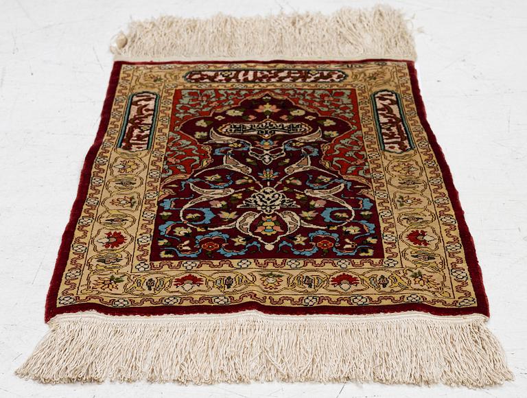 A silk and metal Hereke rug, West Anatolia, c. 58 x 39 cm.