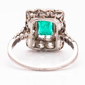 A platinum ring with an emerald ca 0.71 ct and old cut diamonds ca 1.66 ct in total.