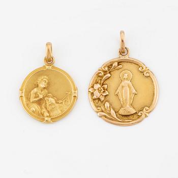 Two 18K gold medallions.