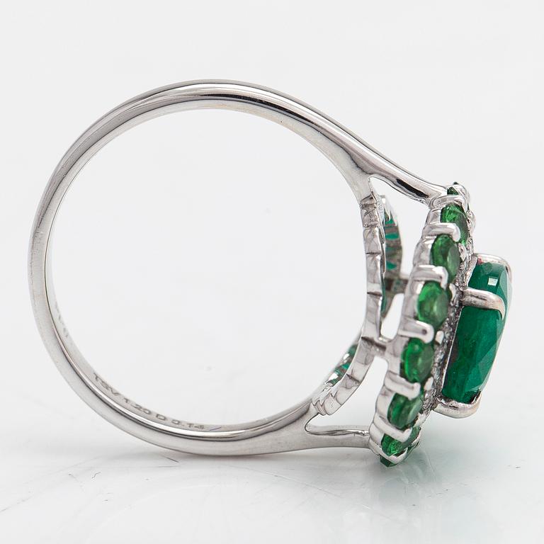 A 14K white gold ring with an emerald  2.33 ct, tsavorites 1.20 ct and diamonds ca 0.14 ct. With IGI certificate.