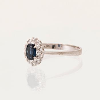 An 18K white gold carmosé ring set with an oval faceted sapphire and round brilliant-cut diamonds, Alessandria Italy.