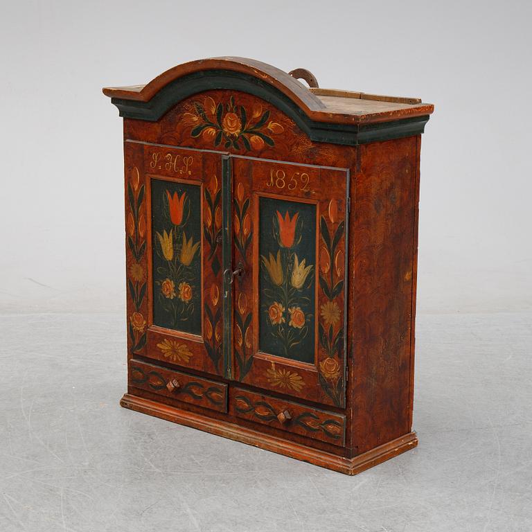 A Swedish provincial painted wall hanging cabinet, dated 1852.