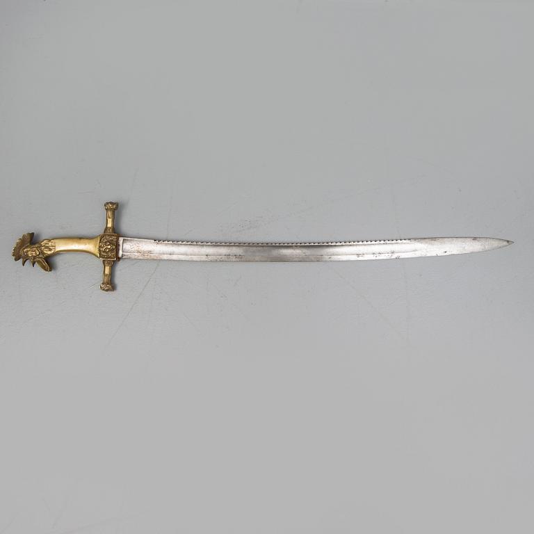 An early 19th Century Napoleonic rooster head sword. Curved blade with saw back marked Manufacture de Klingentahl Coleau.